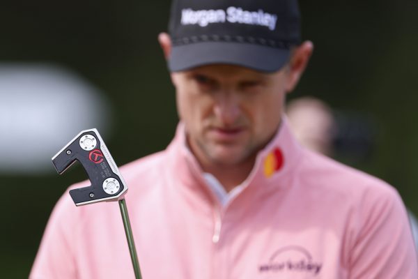 justin rose reading a putt during the masters practice round.